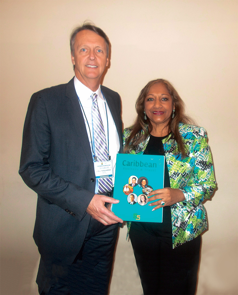 Former Westjet Vice President Lyle Faquharson with a copy of the first edition of the Caribbean Business & Travel publication with Editor Sandra Ann Baptiste of the Caribbean Business & Travel magazine and its Editor.