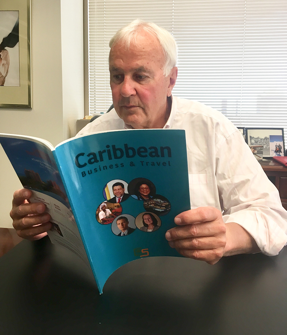 Former Premier of Ontario, Canada, David Peterson checks out the first edition of Caribbean Business & Travel (CBT).