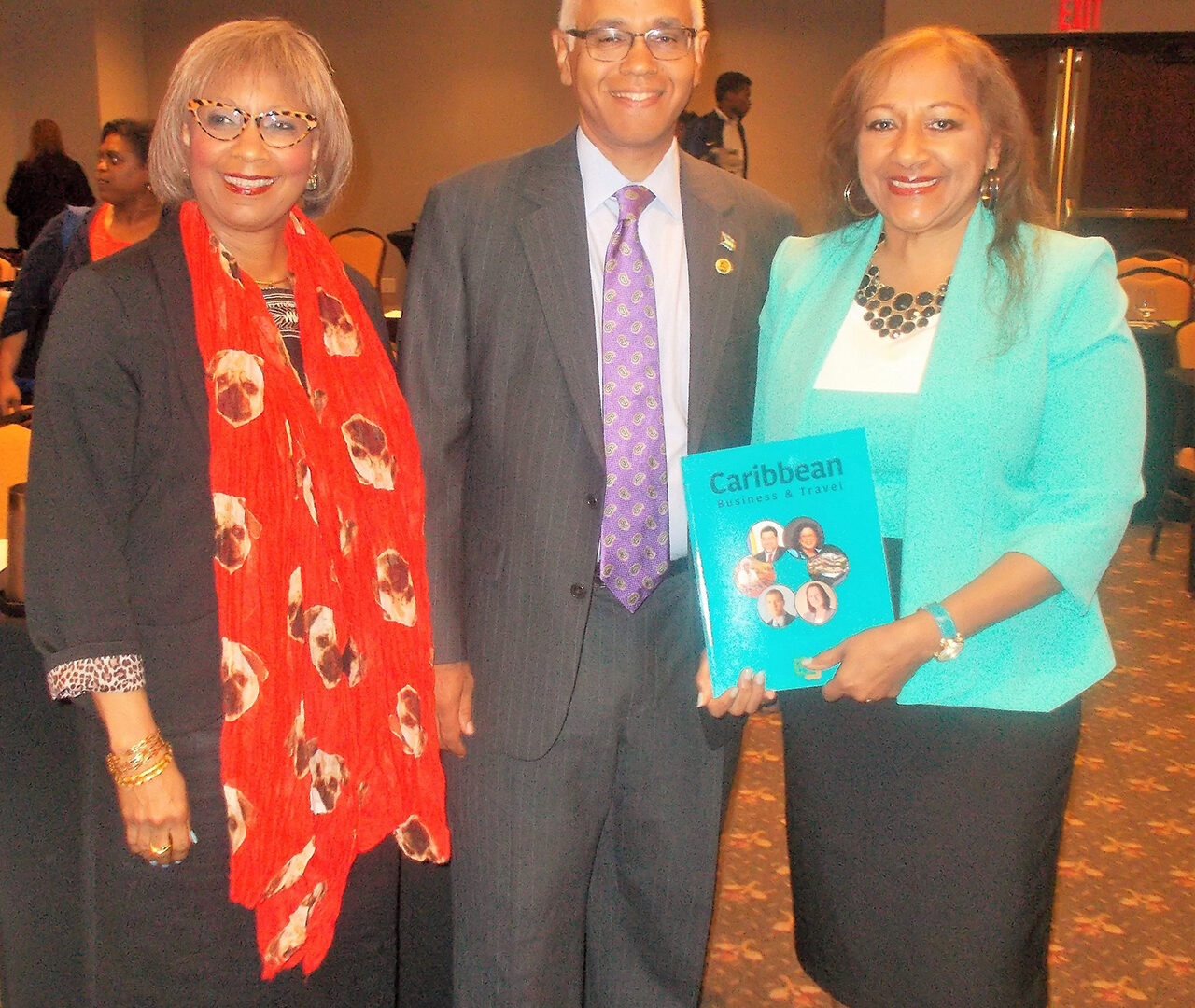 Editor of the Investment Guide, Sandra Ann Baptiste, proudly displays the publication.