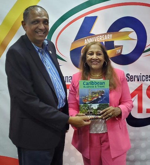 President of the Guyana Manufacturing & Services Association (GMSA) Ramsay Ali receives a copy of "Caribbean Business & Travel" from Sandra Ann Baptiste