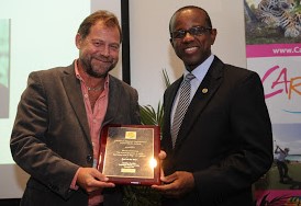 Our Travel Writer, Canadian Mark Stevens, receives an Award from former CTO Secretary General Hugh Riley