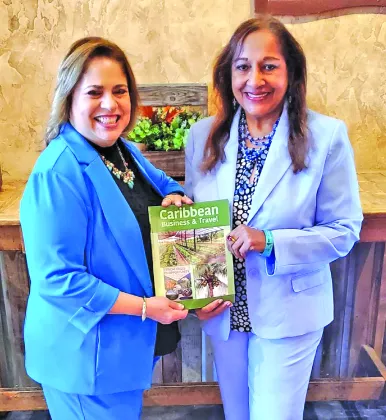 Senior Vice-President for International Business at the Greater Miami Chamber of Commerce, Liane Ventura, receives a copy of Caribbean Business & Travel from the Chief Executive Consultant of Carigold Signature, Sandra Ann Baptiste