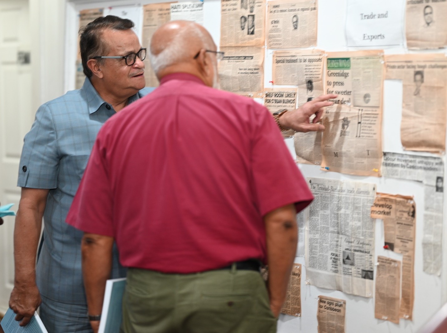 Gerry Gouveia and former President Donald Ramotar view some of the articles on display that are featured in the Caribbean Perspectives book.