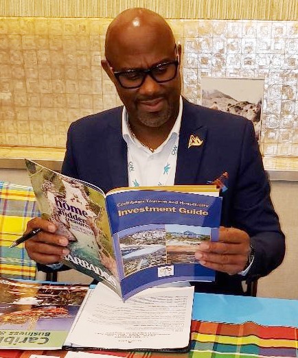 Dexter Percil, Head of Marketing of the Saint Lucia Tourism Authority, checks out the Investment Guide during CTO Caribbean Week in New York.